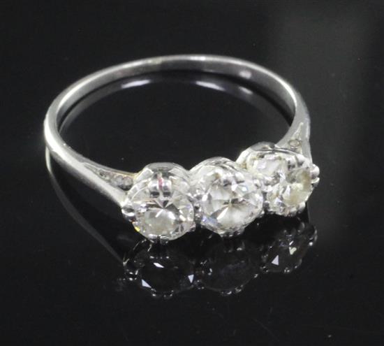 A mid 20th century white gold and three stone diamond ring, size N.